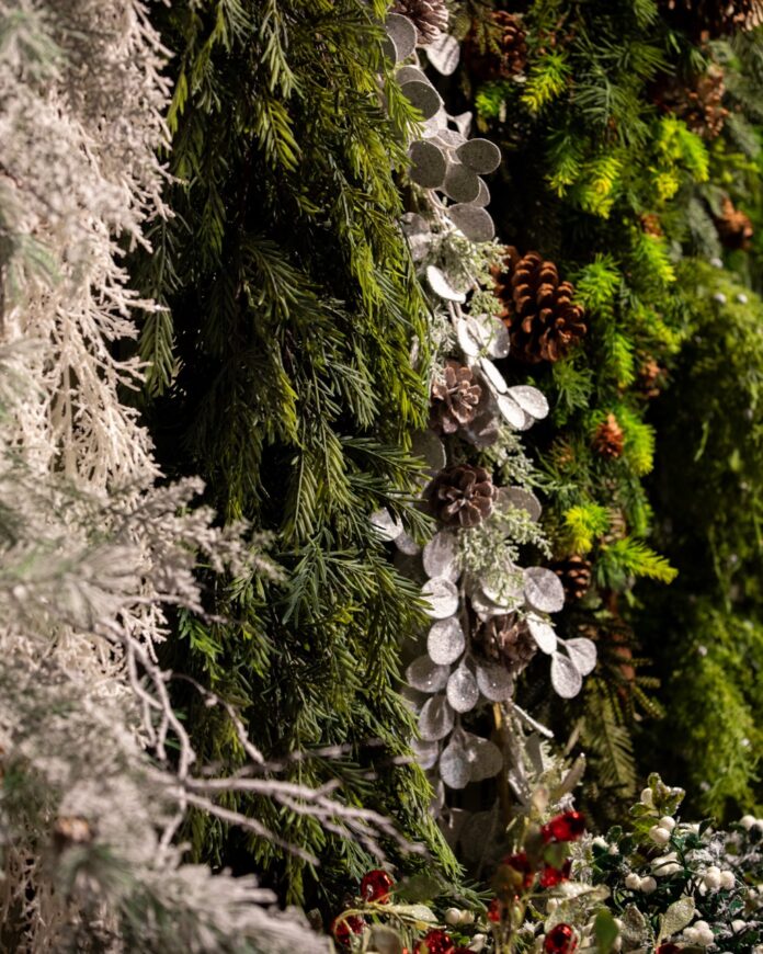 Must-Shop Pittsburgh Holiday Markets and Nurseries Various strings of pine hang in green and white colors with pinecones throughout.
