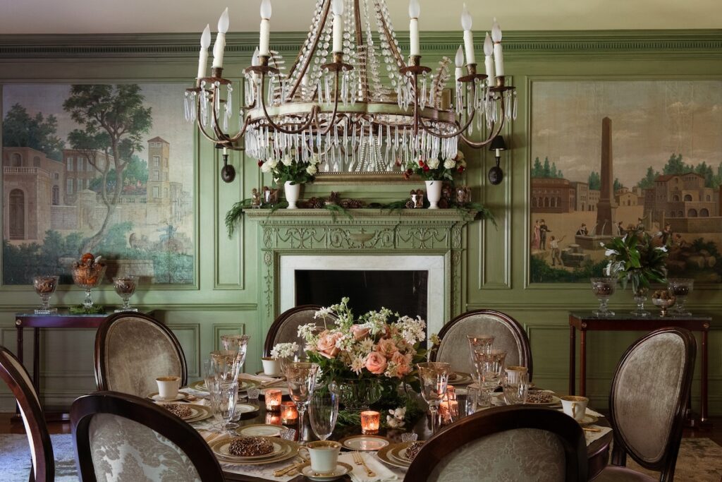 A chandelier hangs over Gwen Martin's holiday dinner table in a softly painted green room