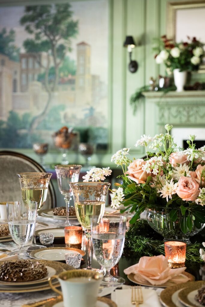 A table set with coupe glasses and green walls