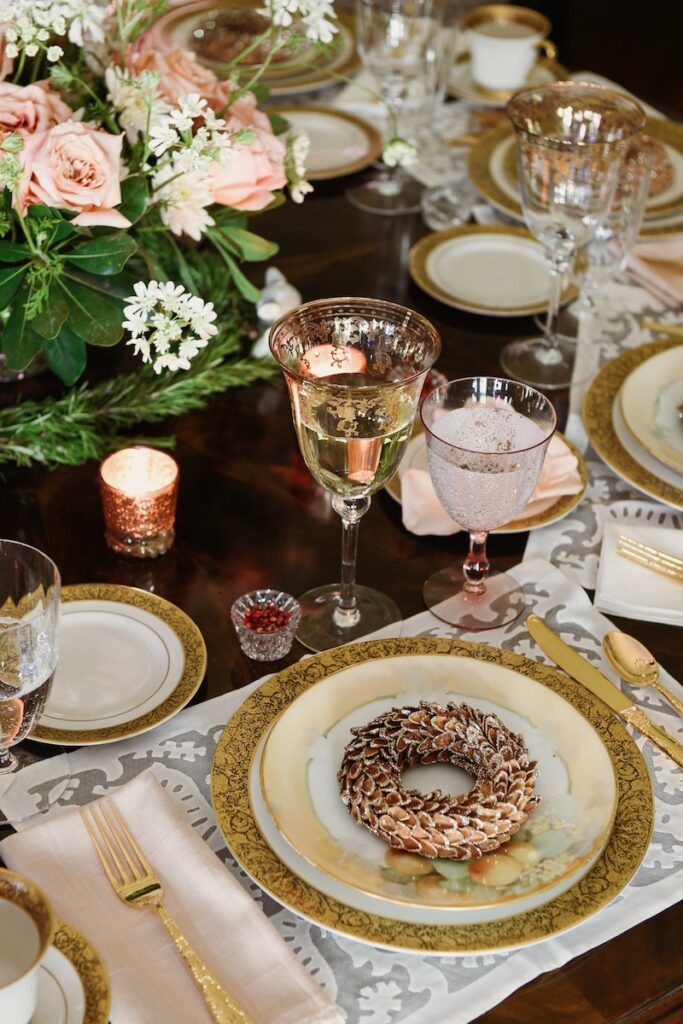 A table setting at Gwen Martin's Sewickley home with a small bagel and a coupe glass on porcelain tableware