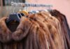 Spend Black Friday in Pittsburgh in Luxury A rack of light brown furs from Carl W. Herrmann, a Pittsburgh store open on Black Friday