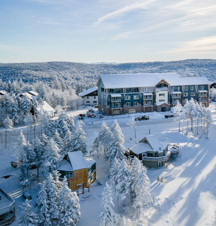 Ski slopes and a ski lodge at Snowshoe, a ski destination near Pittsburgh coated in white snow on a winter day