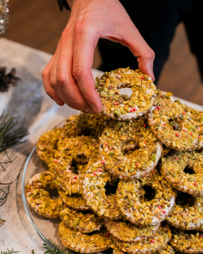 A pile of pistachio wreath cookies