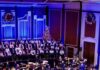 5 Pittsburgh Events This Week (December 8-14) On the Heinz Hall stage in Pittsburgh is the orchestra being conducted under Christmas lights with trees in the background.
