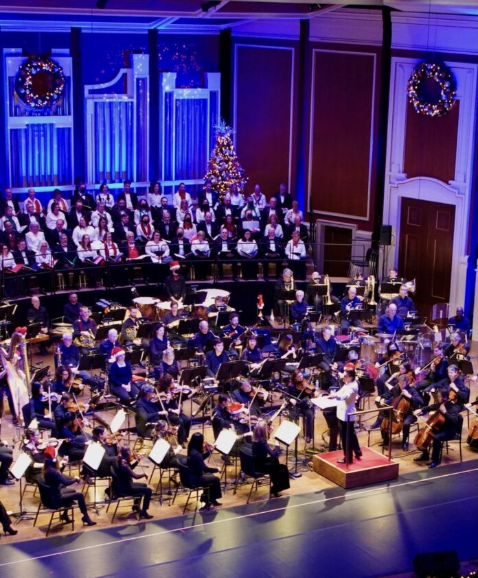 5 Pittsburgh Events This Week (December 8-14) On the Heinz Hall stage in Pittsburgh is the orchestra being conducted under Christmas lights with trees in the background.
