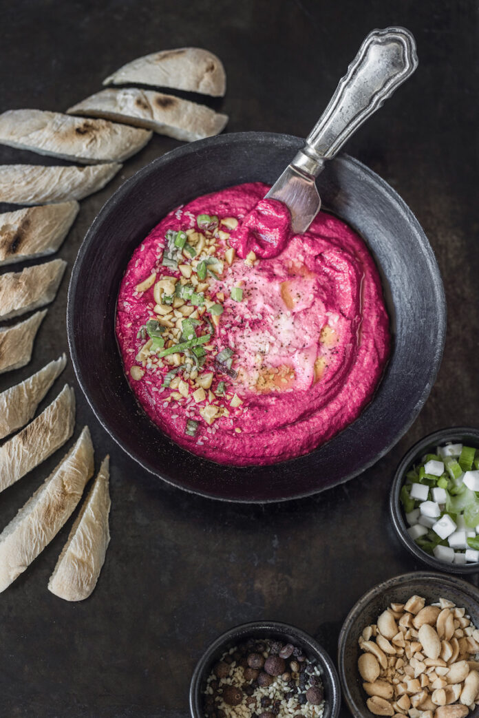 Red Beet and Yogurt Mousse 2 Lrg A pink bowl of beet and yogurt mousse with garnish on top of it