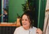 Proust Questionnaire with Chef Jamilka Borges Chef Jamilka Borges sits at a table with a glass of wine in front of her.