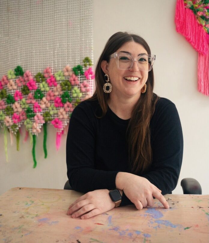 Madison Manning in her studio space, surrounded by her work.