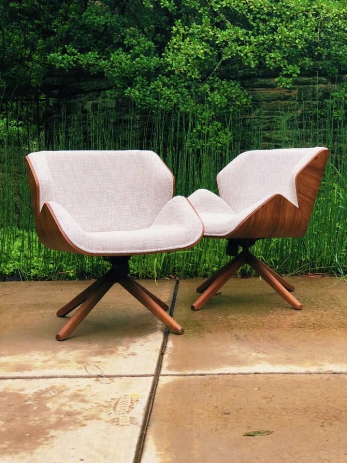 Two chairs by Santom Upholstery on a green background.