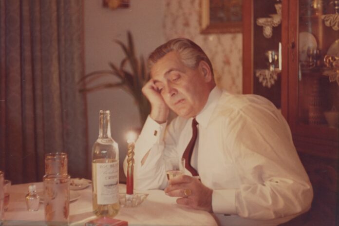 Titusz Csilla Thackray's Hungarian great-grandfather sits at a table, looking pensive.