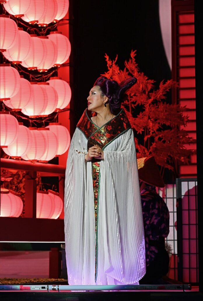 Spring Theater A woman dressed in the costume for Cho-Cho San in Madama Butterfly on a red opera stage