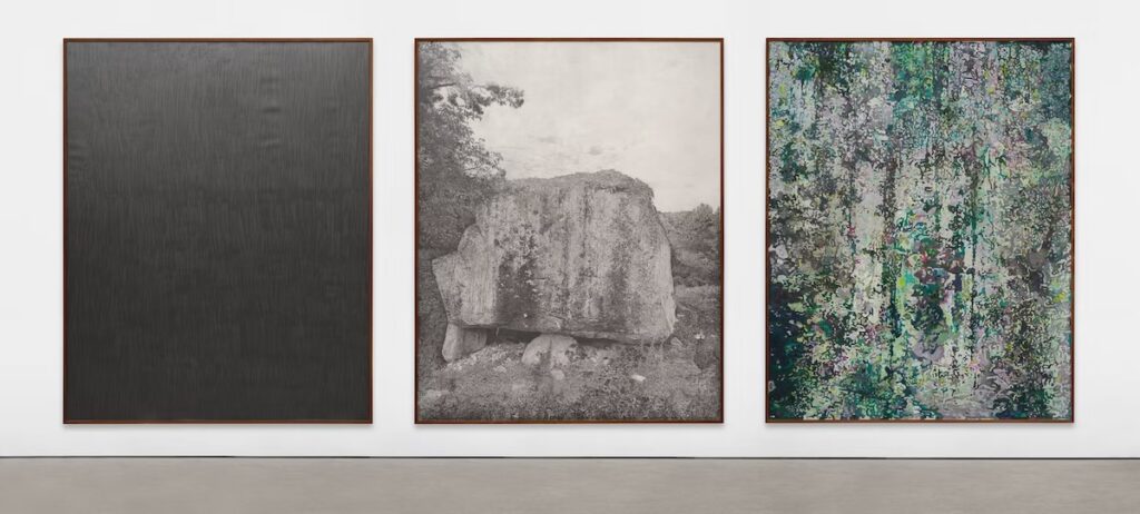 A triptich of three large paintings, one black, one graphite grey, and one green. 