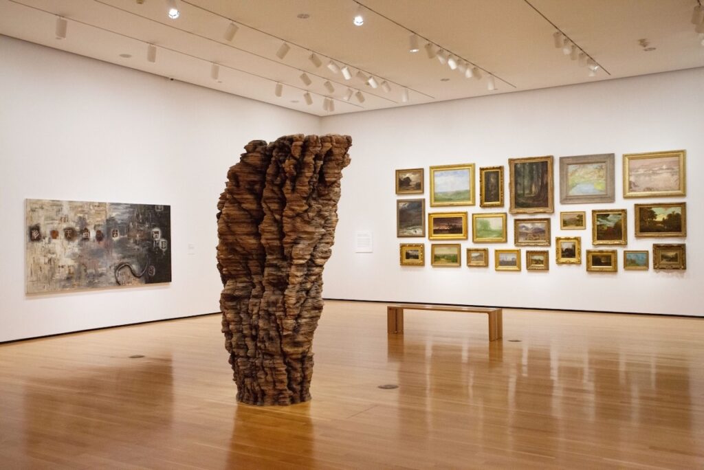 The interior of the Akron Art Museum with wooden floors and a white wall. 