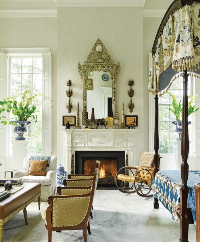 Bunny Williams Comes to Carnegie Museum of Art in April Bunny Williams design of a living room with a mirror on the fireplace and vintage furniture around the room.