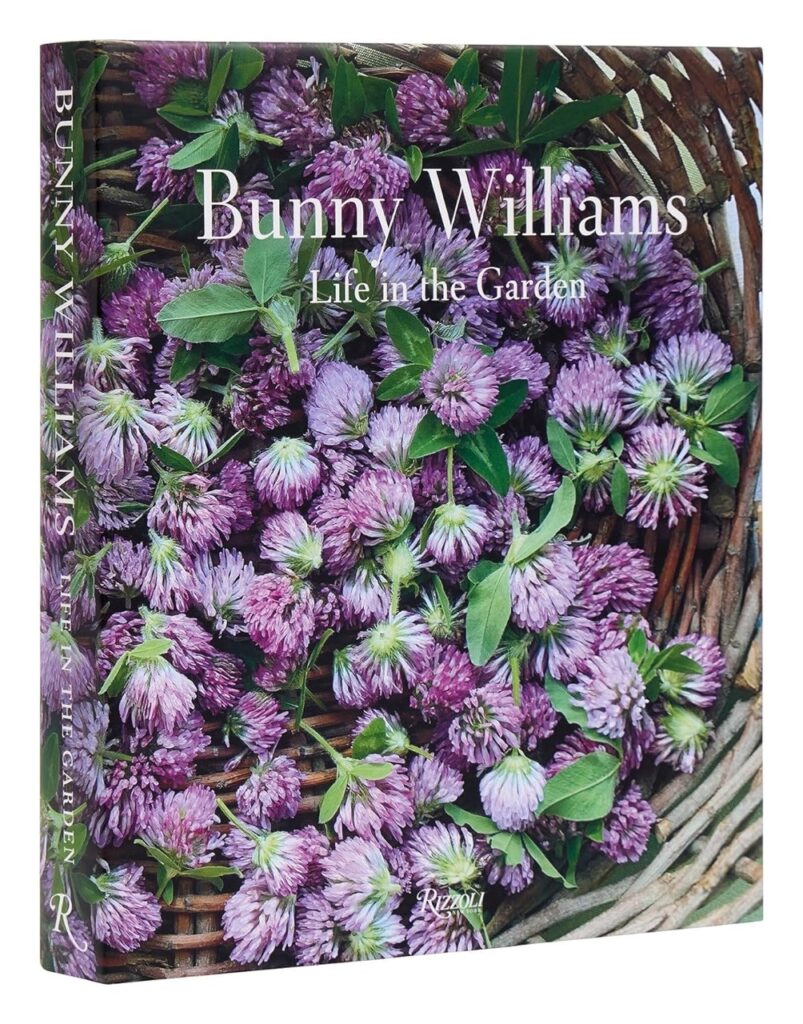 The cover of Bunny Williams book with purple flowers in a basket. 