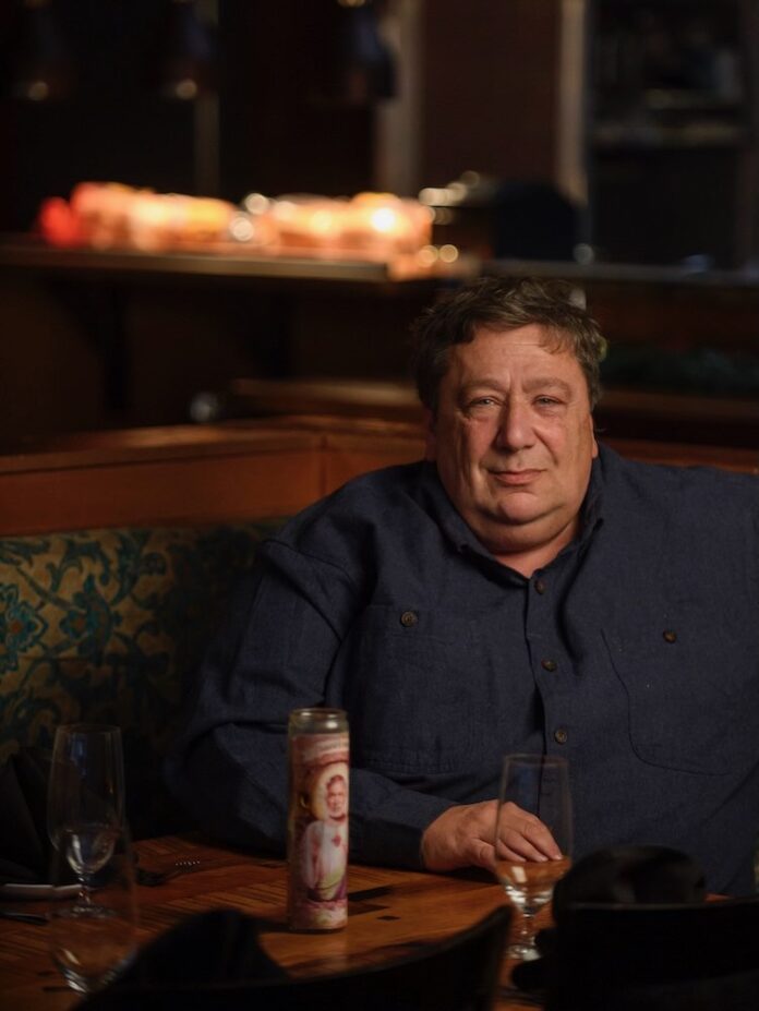 Chef Christian Frangiadis sits at a table in Spork, his restaurant.