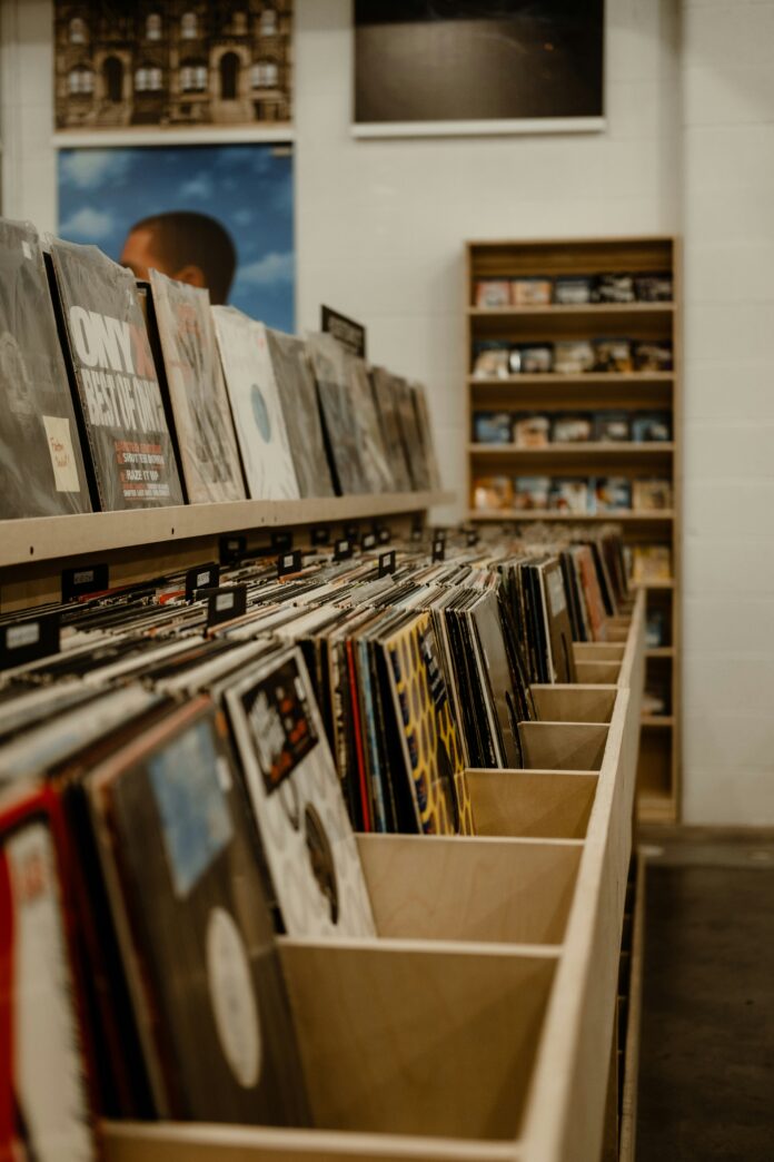 Vinyls on record racks in various wood bins at a record store in Pittsburgh.