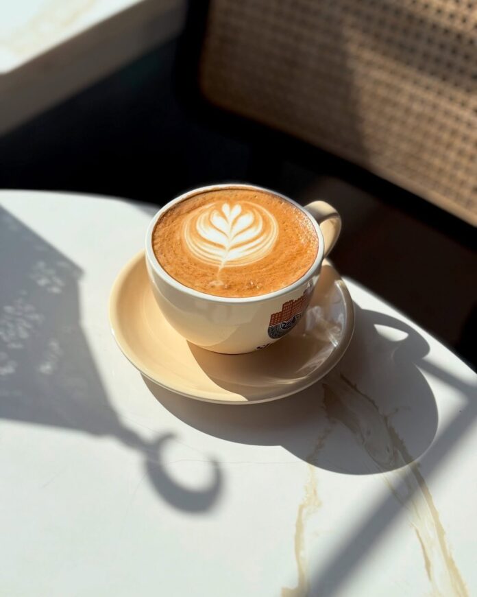 Shibam Coffee A cup of coffee from Shibam Coffee on a white table.