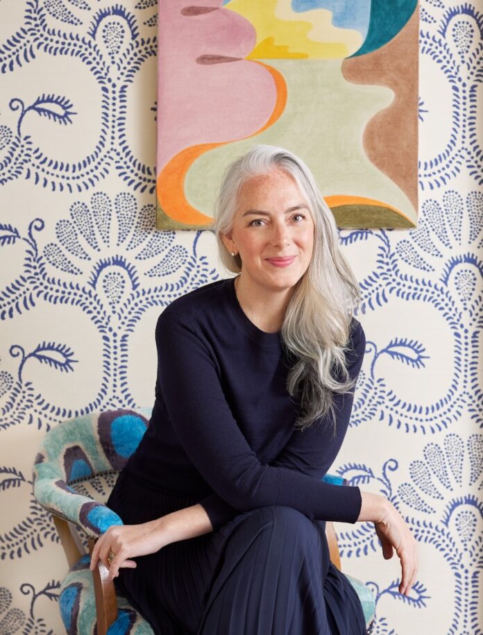 Colleen Simonds in front of her signature wallpaper.