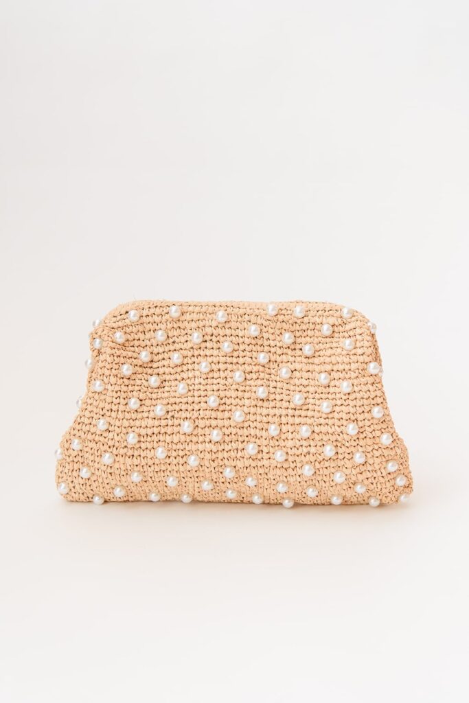 A warm peach beaded purse with small pearls all over it.