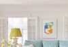 Colleen Simonds Updates a Charming New Jersey Farmhouse A light blue patterned couch with a green pillow on it and a green lamp to the left sitting in a living room.