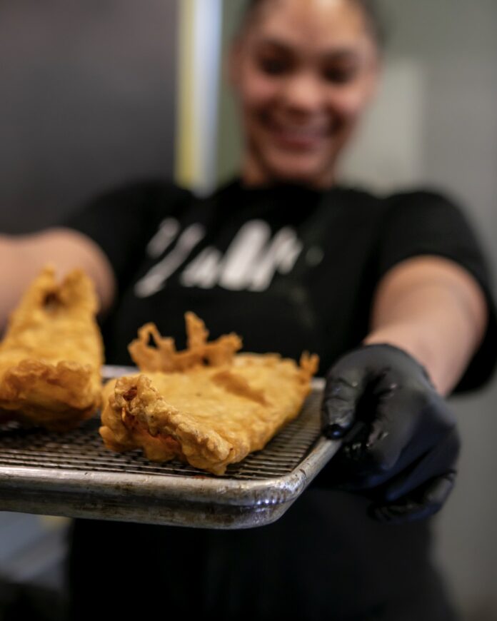 Find a Fish Fry Around Pittsburgh During Lent A girl holds a plate of fried fish.