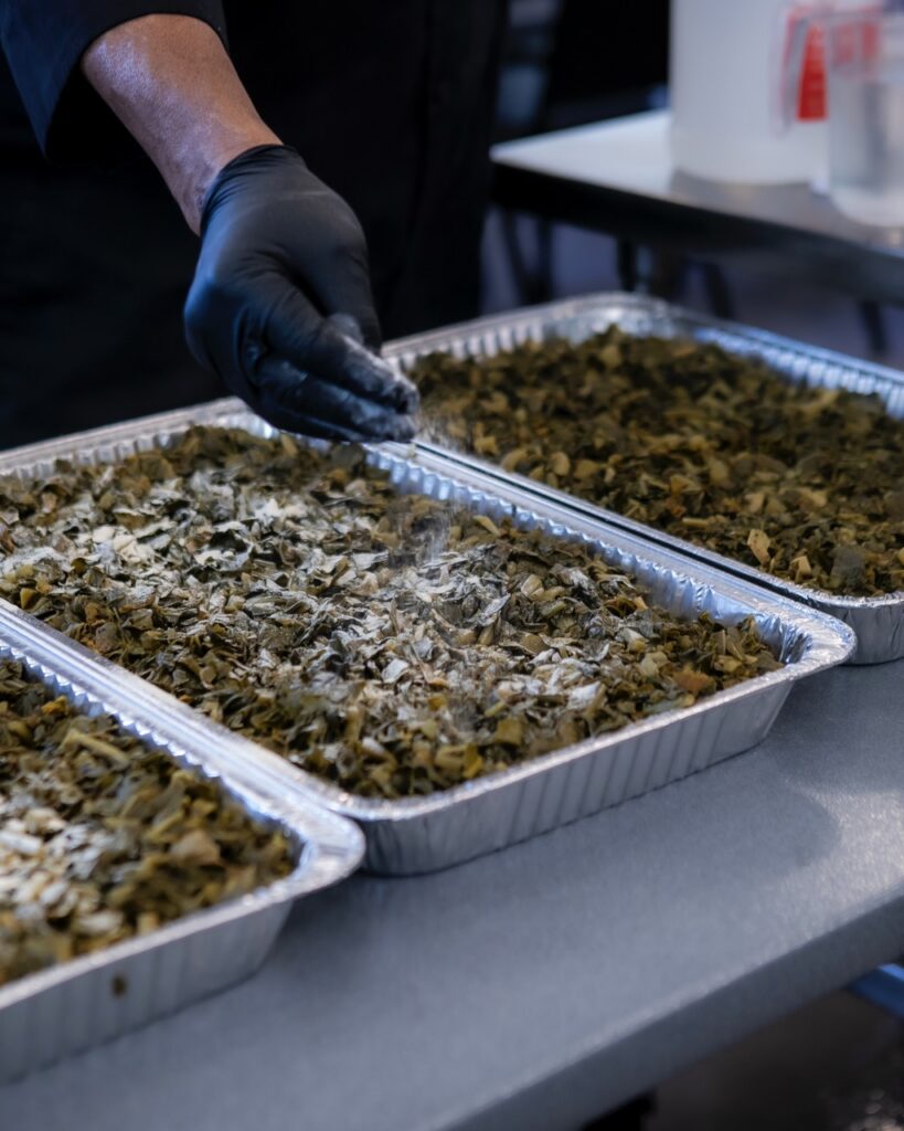 A man salts collard greens.