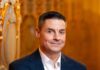 Pittsburgh Symphony Orchestra Appoints James Santilli to Senior Vice President James Santilli with the Pittsburgh Symphony Orchestra stands in a suit jacket in front of a wall in the theater.