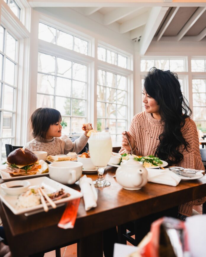Mother's Day Events TABLE Magazine A mother and child sit at a Mother's Day tea at a cafe table in The Frick.