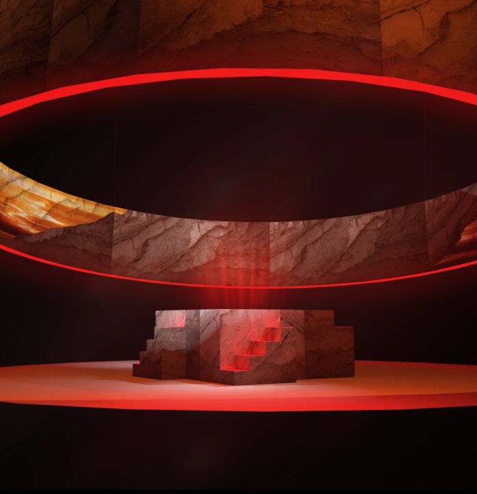 The stage of Pittsburgh Playhouse for a theatrical event with red lights on a stone staircase on a stage.