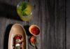 Buckwheat Blini Recipe Buckwheat Blini served on a long plate with jam as a topping with a drink and a spoon on the side
