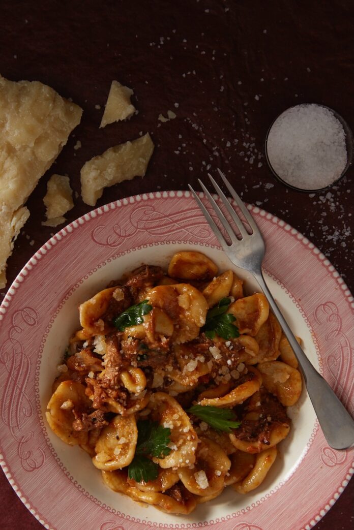Handmade Orecchiette Pasta A plate of handmade orecchiette pasta with a meat sauce.