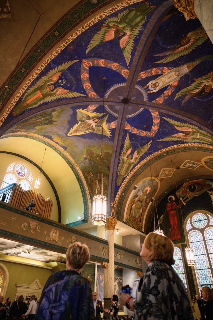 A group of guests enjoy looking at the Maxo Vanka murals.