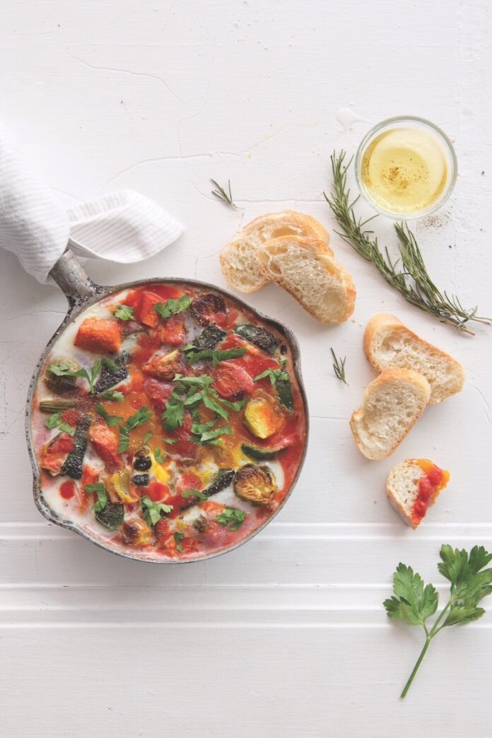 North African Shakshouka A plate of North African shakshouka staged with crusty bread.