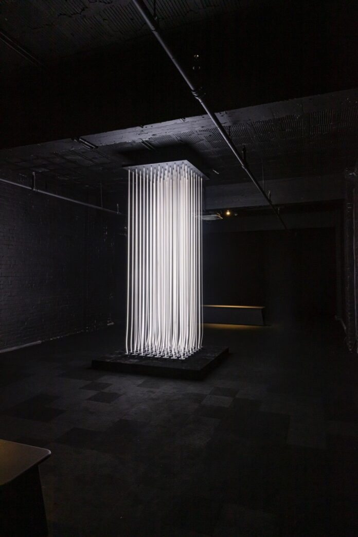 An art show in Pittsburgh 2025 with long string white lights in a rectangular form.