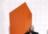 The Best Concerts Coming to Pittsburgh in 2025 A man in a suit stands in front of an orange block on a checkerboard floor.