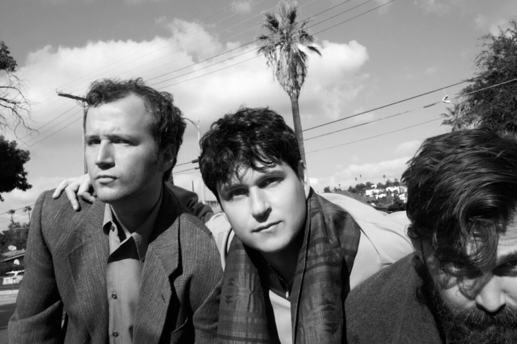 A photo of the band Vampire Weekend with three men outside as a Pittsburgh concert.