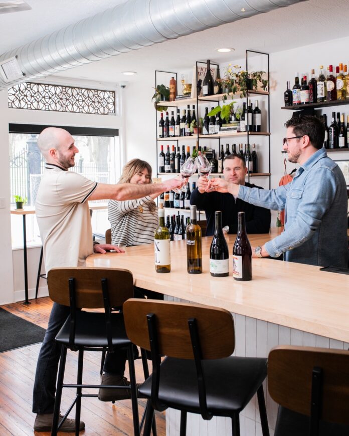 A group of people cheers at one of Pittsburgh's wine bars.
