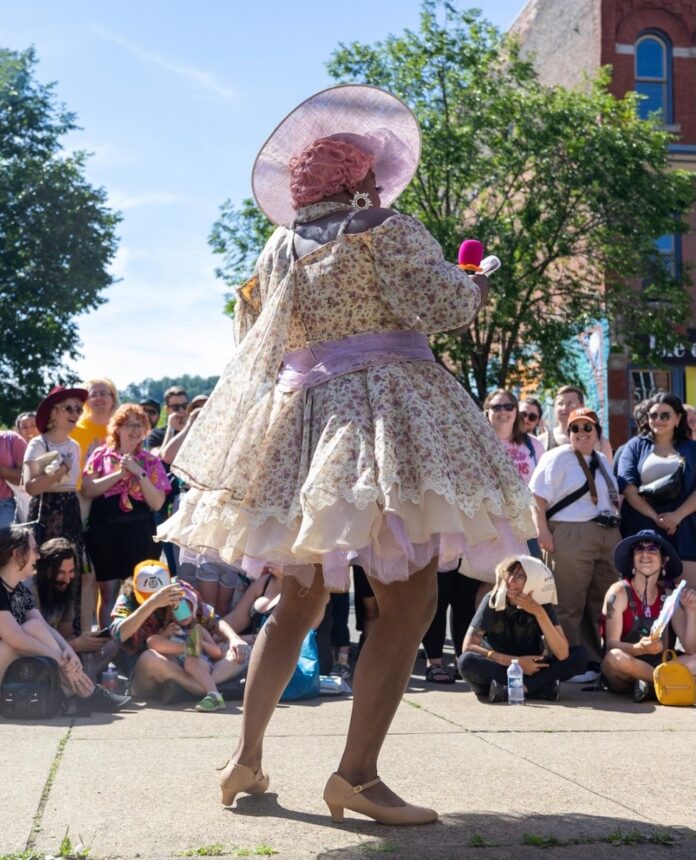 Celebrate Pride Month 2025 in Pittsburgh A drag queen dances at the Lawrenceville Pittsburgh Pride event in front of a crowd of people outside.