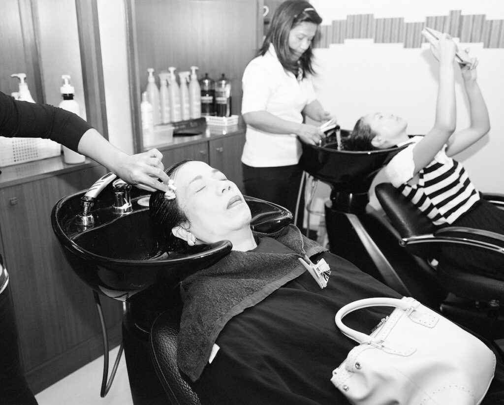 An image by Paolo Morales of his mother at a hair salon in the Philippines.