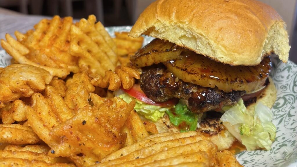 A close-up photo of a burger and fries from Nick's on Hilltop.