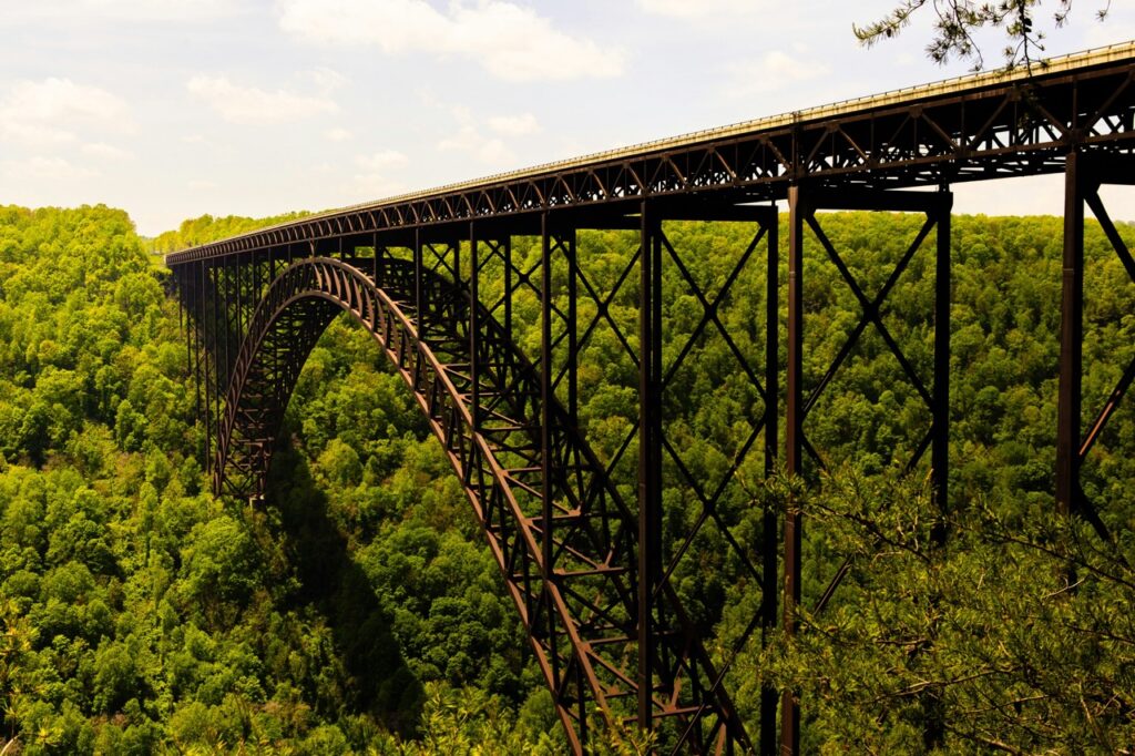 A large bridge in West Virginia sits over an Appalachia forest.