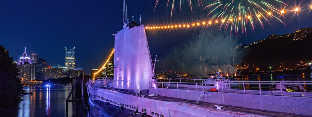 The ship at the Carnegie Science Center lit up by fireworks in Pittsburgh from a fourth of July event. 