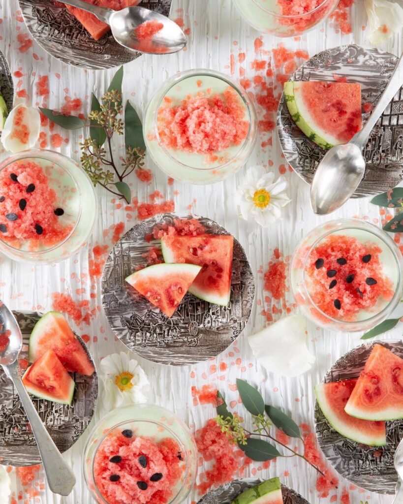 Lime Posset & Watermelon Granita in small glass dishes with spoons.