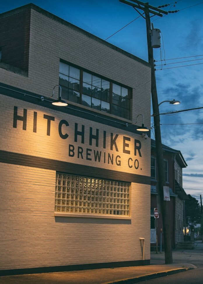 Hitchhiker Brewing Co. in Mt Lebanon at night with lights showing off the sign.