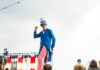 Pittsburgh Events: Your Guide to June 30-July 6 A man with long pinstriped pants and a blue jacket stands on stilts in front of children at a Fourth of July event in Pittsburgh.