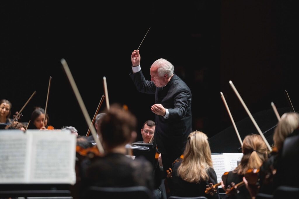 A conductor conducts the Pittsburgh Symphony in a fourth of july concert event. 