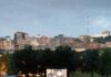 Free Summer Movie Series Around Pittsburgh Groups of people on blankets and in chairs sit in a Pittsburgh park watching a free summer movie series on an inflatable screen in front of the city skyline.