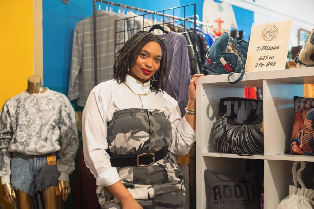Fashion designer Imani Batts stands in front of her work.
