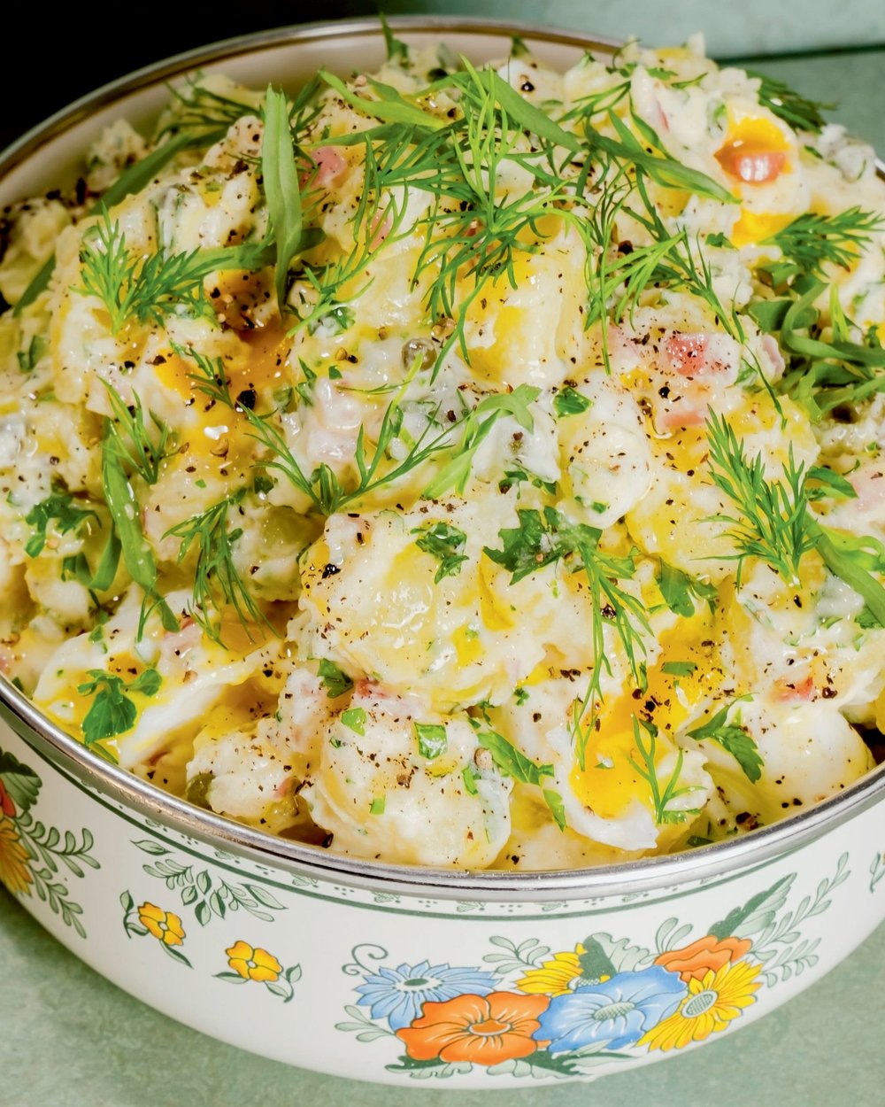 The Best Potato Salad served in a steel food container cut from the sides